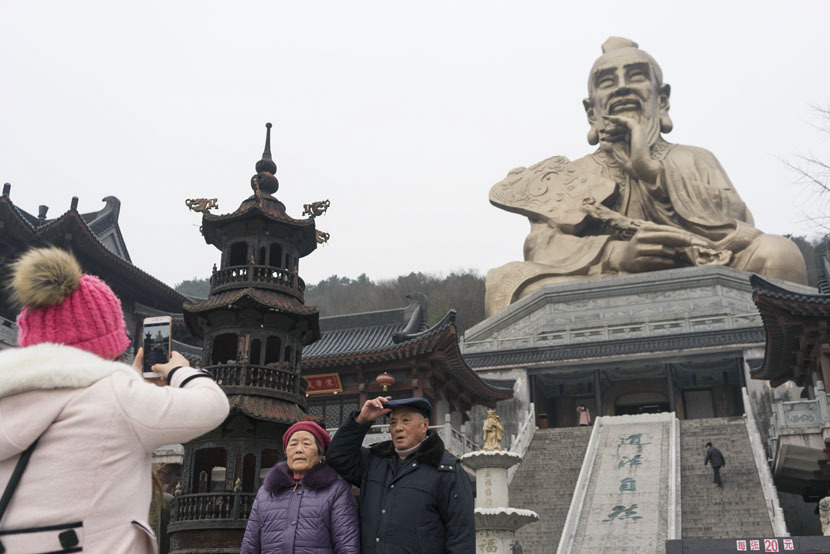 Tourists take photos at the entrance of Yuanfu Wanning Taoist Temple, Jurong City, Jiangsu province, Jan. 10, 2017. The complex includes a massive statue of Lao-tzu, the founder of Taoism.