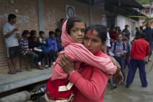 Women holds daughter after powerful earthquake shook eastern Nepal near Mount Everest on Tuesday