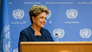 President Dilma Rousseff smiling on a podium. She is presenting the country's national climate plan at the UN in New York