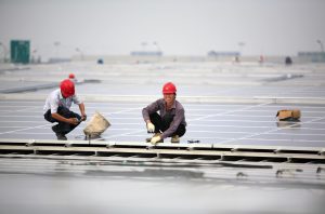 <p>Chinese workers install solar panels in Shanghai&nbsp;(Image by jre /&nbsp;Jiri Rezac)</p>