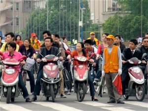 <p>Electric bikes waiting for the traffic signal in Chengdu, Sichuan. (Image by </p>