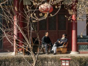 Ren Farong (right) chats with another monk in a courtyard at Louguantai Taoism Temple, Tayu Village, Shaanxi province. (Image: Thomas Cristofoletti for Sixth Tone)