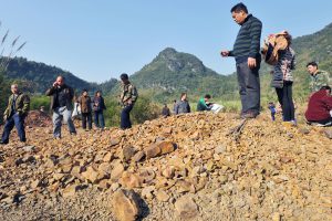 <p>Villagers in Sanhe, Guangxi stand on suspect farm land&nbsp;(Image: Newscom / Alamy)</p>