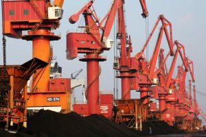 <p>Cranes along a quay load ships with coal to be used for generating electricity at Lianyungang Port, China, October 2019. (Image: Alamy)</p>