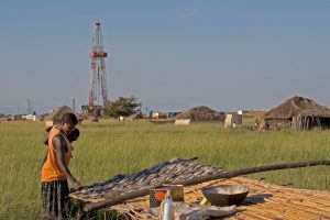 <p>An oil exploration rig stands a stone’s throw from Lake Albert, source of 30% of Uganda&#8217;s fish production. (Image: Alamy)</p>