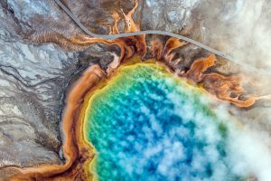 <p><strong>Josh Haner/The New York Times</strong></p> <p>Visitors walk past Grand Prismatic Spring in Yellowstone Park where warming temperatures have brought rapid changes. Winters are shorter. Less snow is falling. Summers are hotter and drier. In a few decades, this iconic American landscape will not be the same.</p>