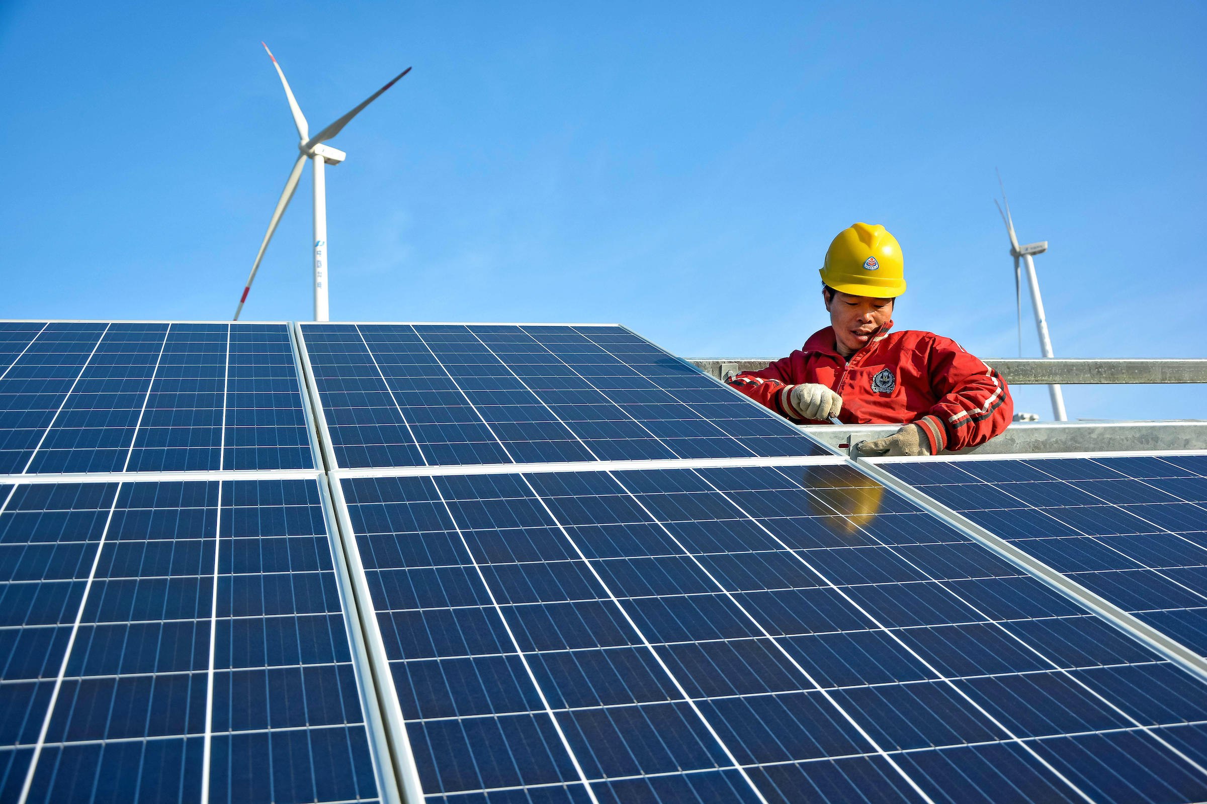 worker installs solar panels in China