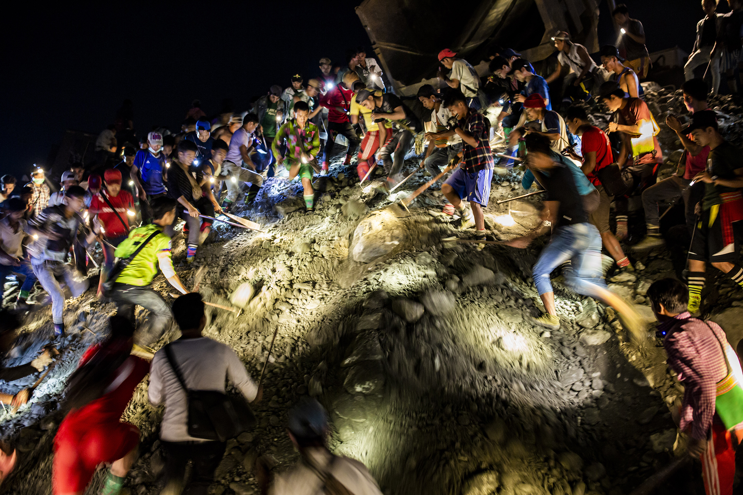 Once the earth stops moving, the miners rush to dig through the rubble in search of overlooked stones. The dangerous working conditions lead to frequent injuries and deaths. (Image © Hkun Lat)