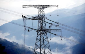 Electricians install power lines near the Xiaowan hydropower station in southwest China's Yunnan province, where coal has played a supporting role in the power mix for years (Image: Alamy)