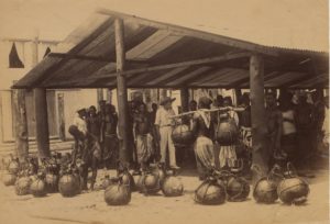 <p>Igbo men in the Oil Rivers area of present-day Nigeria bring calabashes full of palm oil to sell to a European buyer, c. 1900 (Image © <a href="https://www.britishmuseum.org/collection/term/BIOG133873">Jonathan Adagogo Green</a> / <a href="https://www.britishmuseum.org/collection/object/EA_Af-A46-65">The Trustees of the British Museum</a>, <a href="https://creativecommons.org/licenses/by-nc-sa/4.0/">CC BY NC SA</a>)</p>