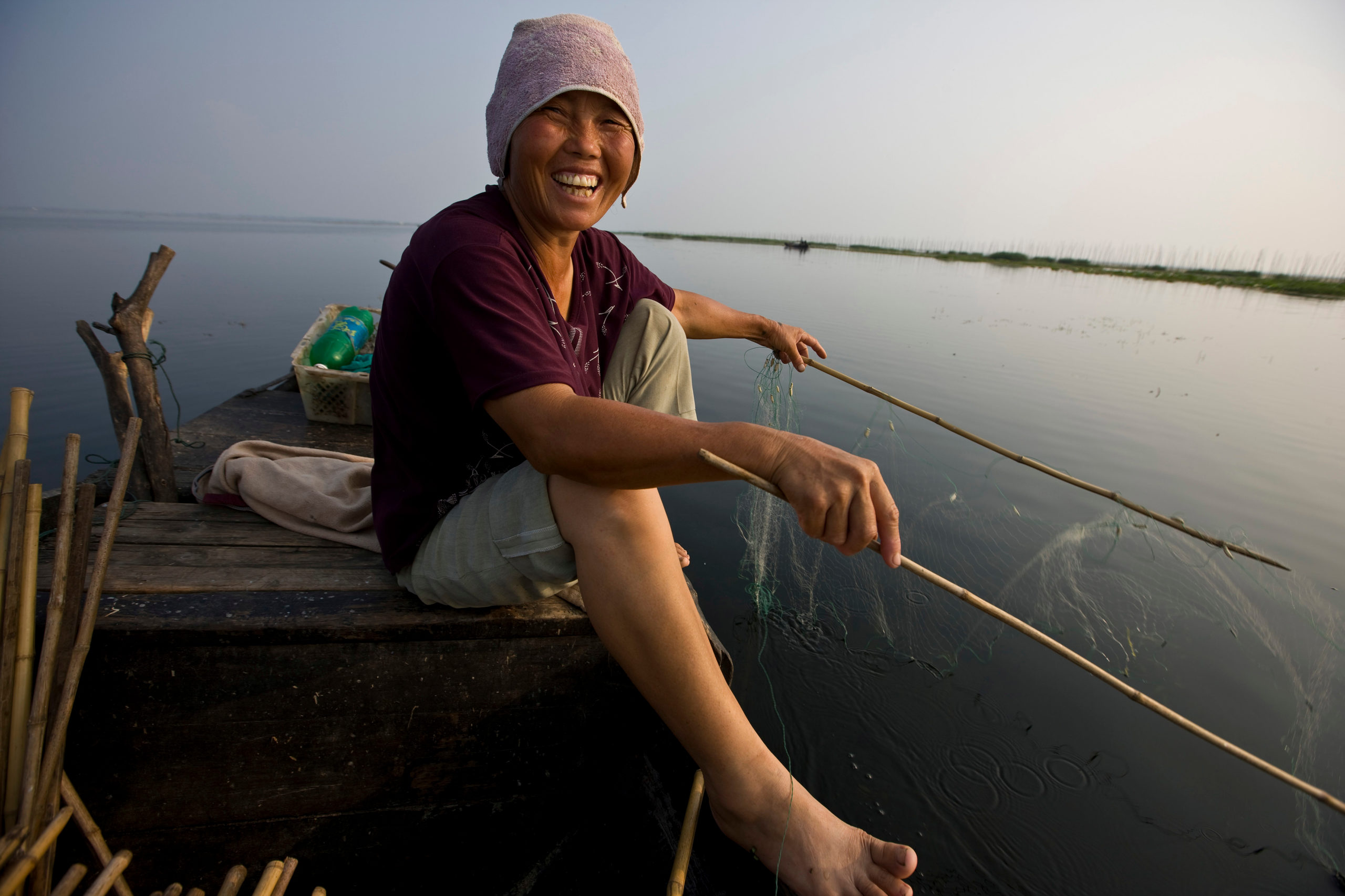 Fisherwoman, Lake Hong, Hubei Province, China, fishing for freshwater fish