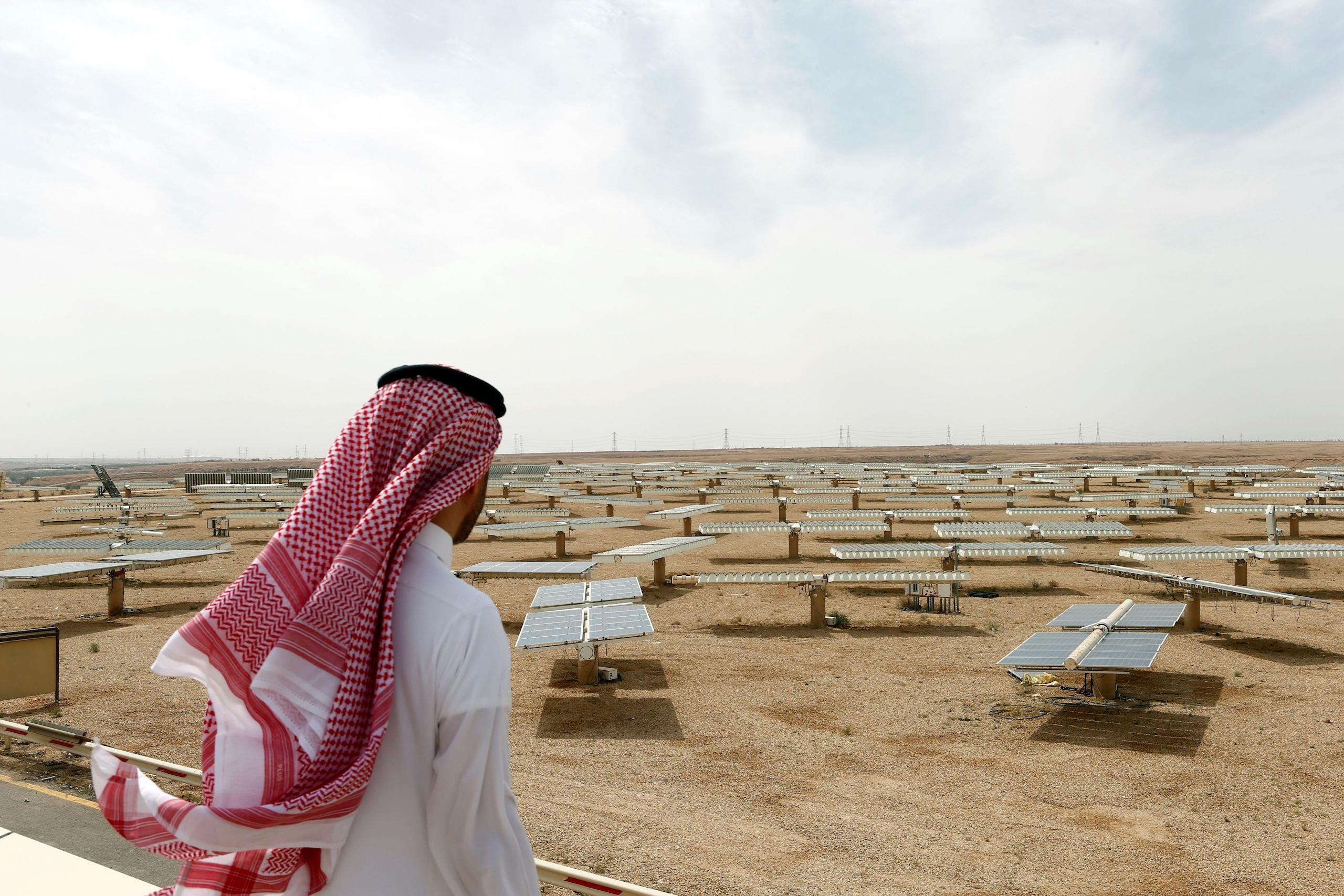 Saudi man looks at the solar plant in Uyayna, north of Riyadh, Saudi Arabia 