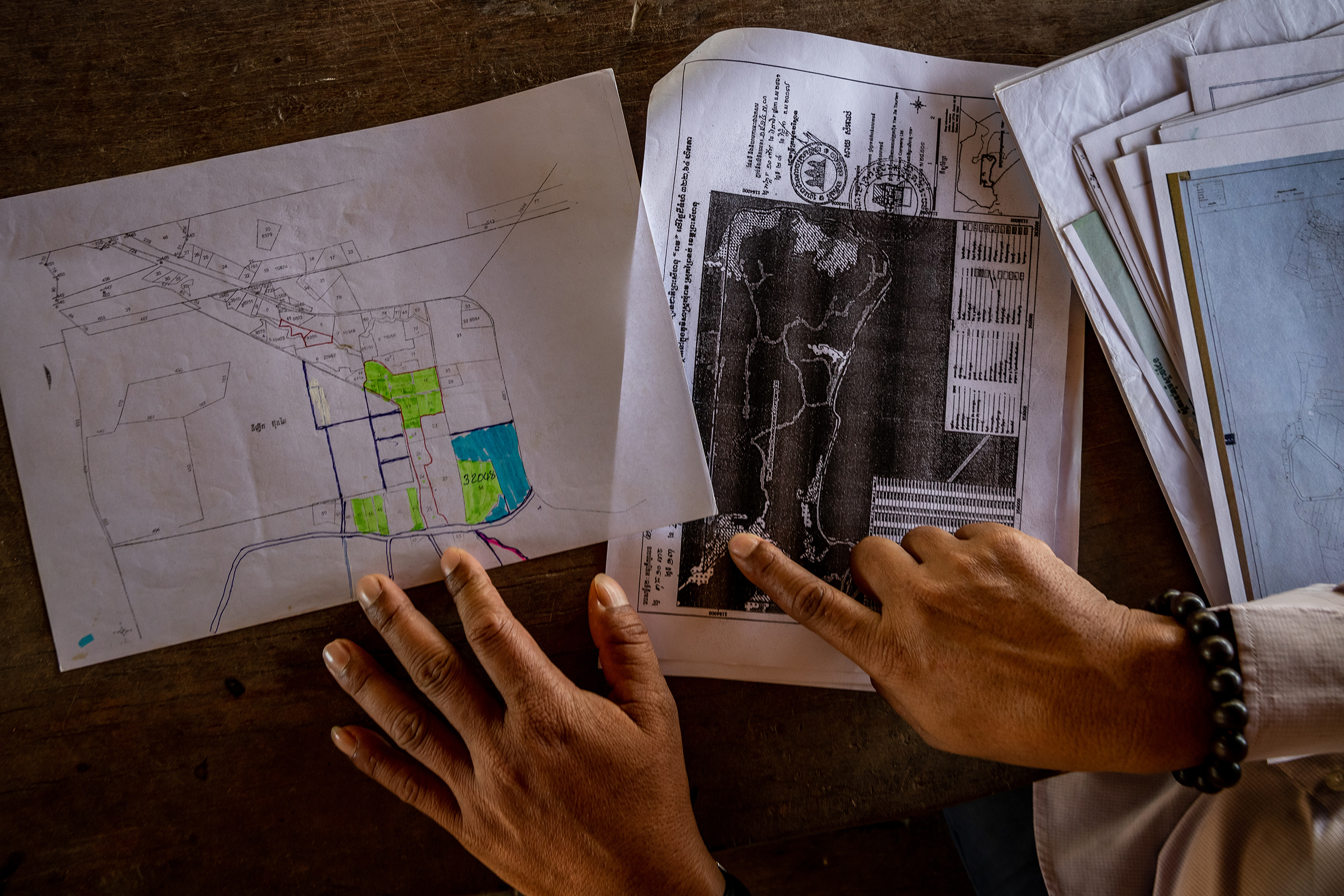 Shop keeper Nam Then points out where the communities of Ream have been promised land originally signed over to Chinese developer, Yeejia