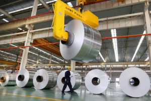 Coiled aluminium sheets at a production plant in Anhui, east China. Aluminium is an essential raw material for emerging sectors such as electric vehicle manufacturing and renewable power (Image: Alamy)