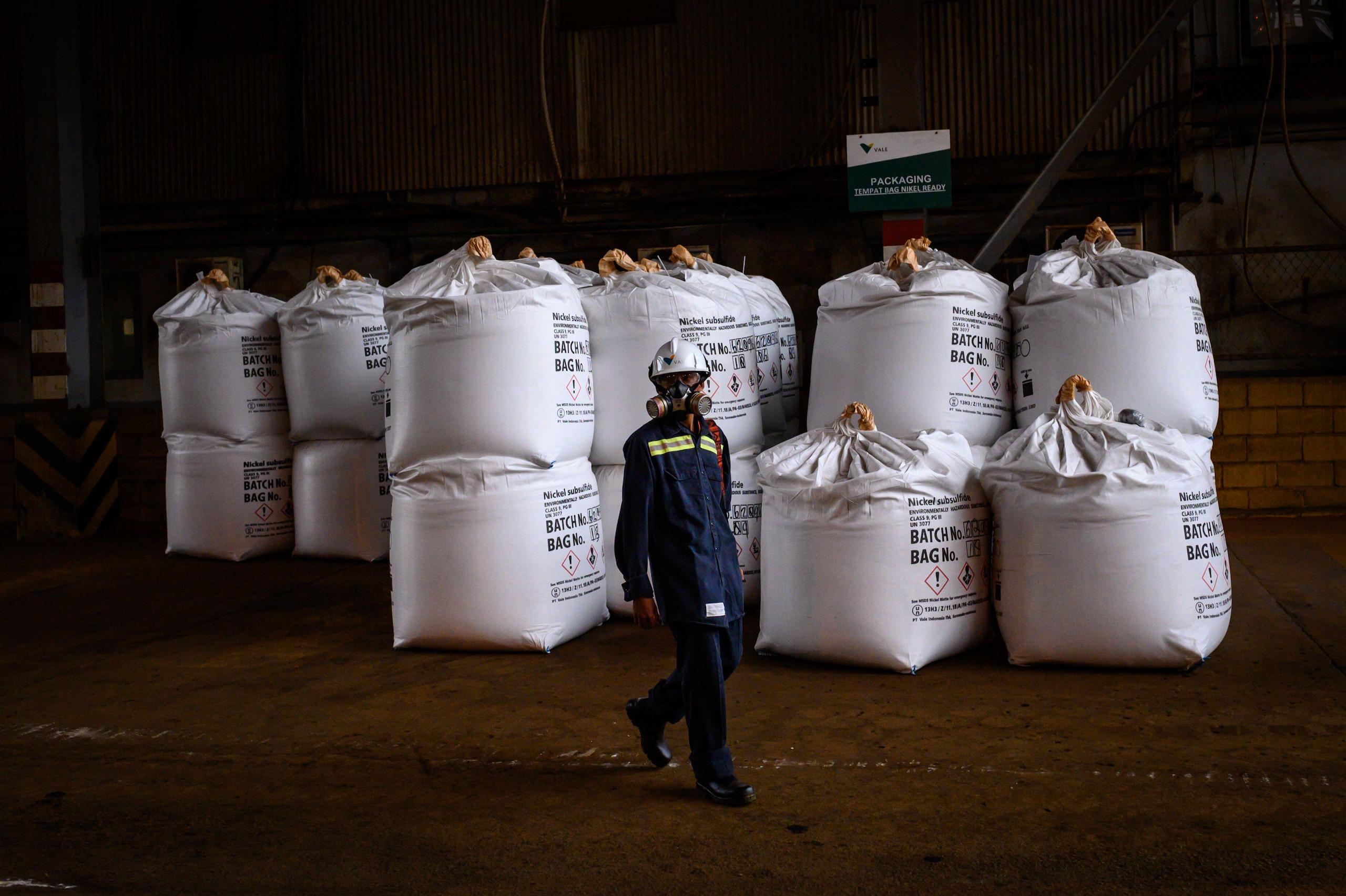 worker next to nickel bags at the PT Vale Indonesia nickel plant.