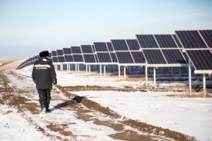 <p>A person walks past solar panels of the Isyangulovo solar power plant in Russia’s Republic of Bashkortostan. With oil and gas playing a major role in its economy, Russia has been slow to move on climate action, but it is rising up Moscow’s agenda. (Image: Alamy)</p>