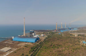 power station by sea with smoking pipes, paiton java, indonesia. aerial view power plant in asia.