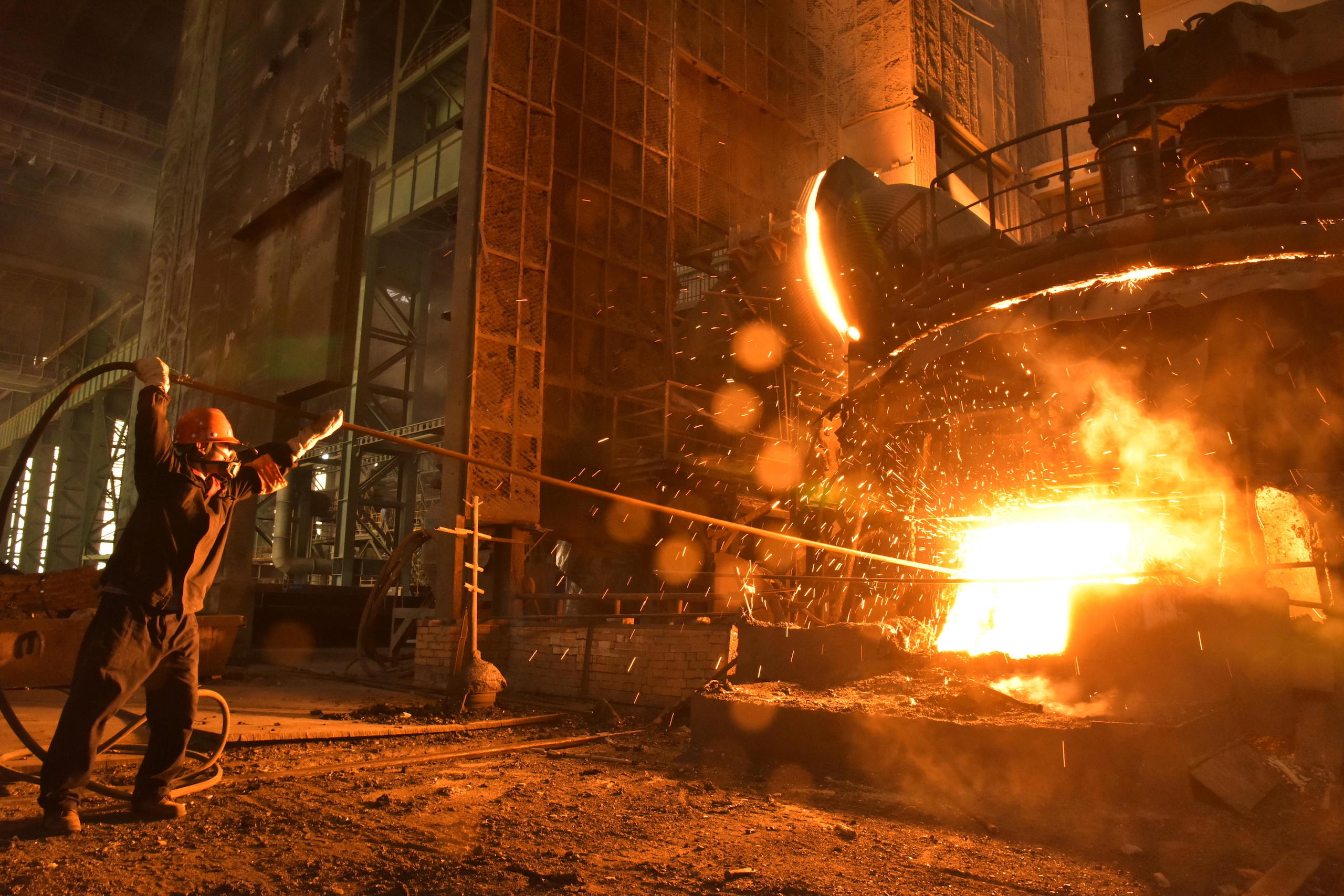 Chinese worker processes steel parts at the plant of Shandong Iron Steel Group