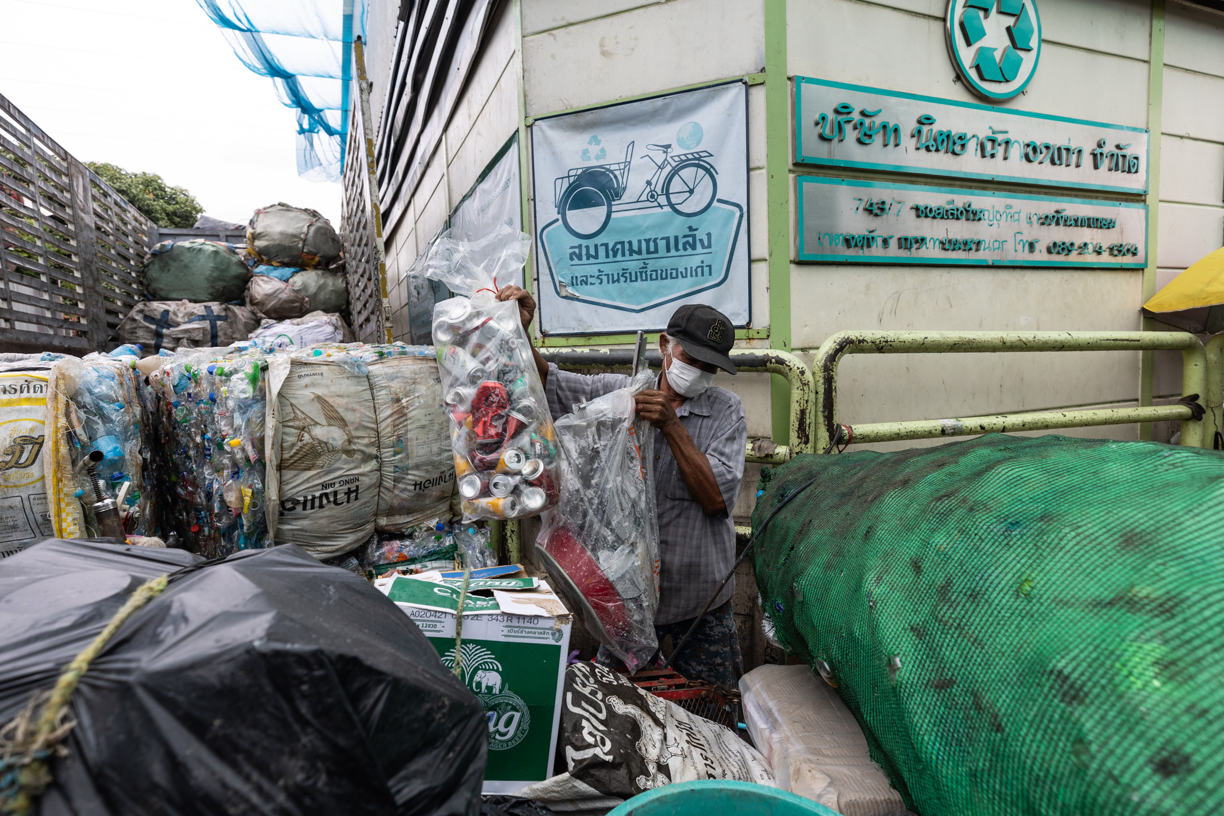 A saleng driver unloads his collected waste to be weighed