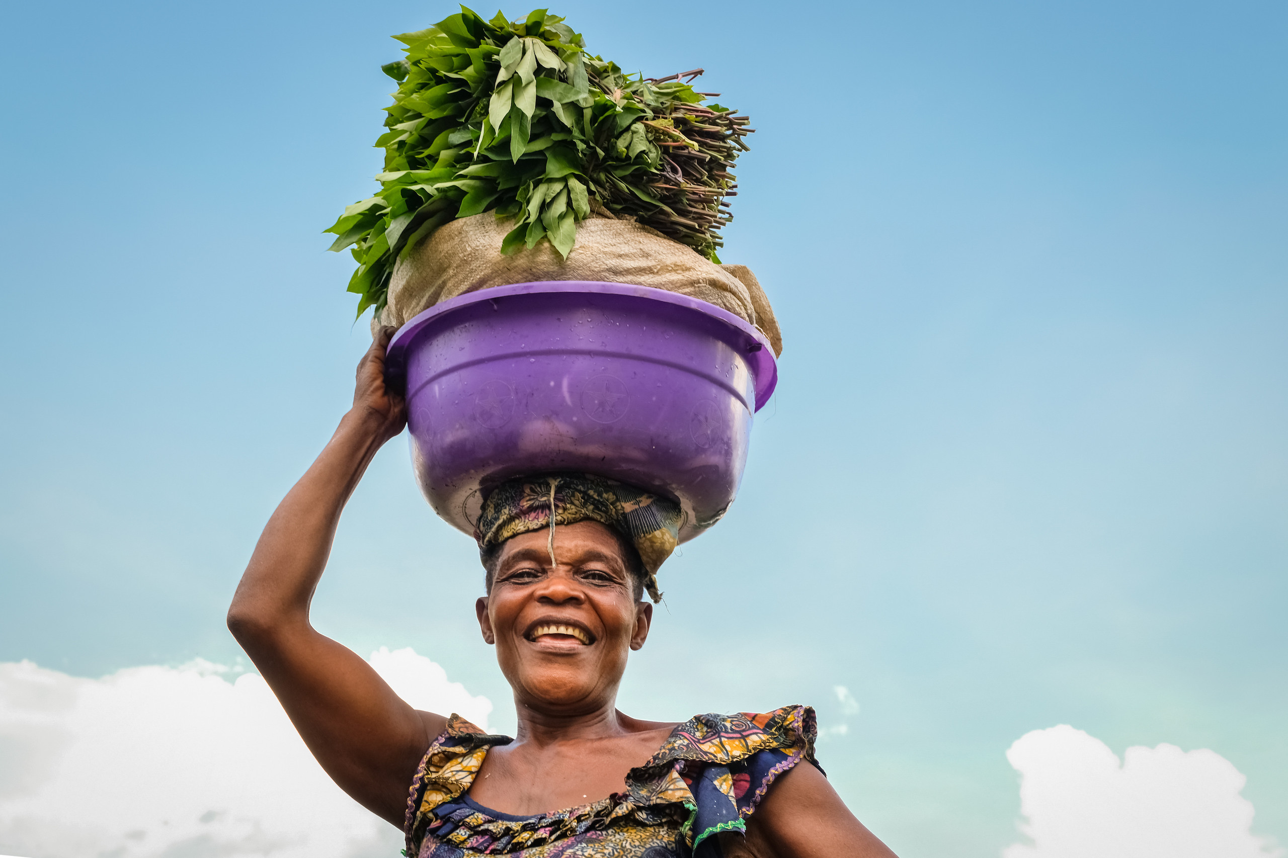 Woman carrying vegetables, Yangole, Democratic Republic of Congo