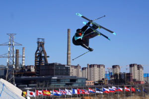 <p>A freestyle skier trains at Genting Snow Park ahead of the 2022 Winter Olympic Games. The park was retooled from the old Beijing Shougang steel mill. (Image: Andrew Milligan / Alamy)</p>