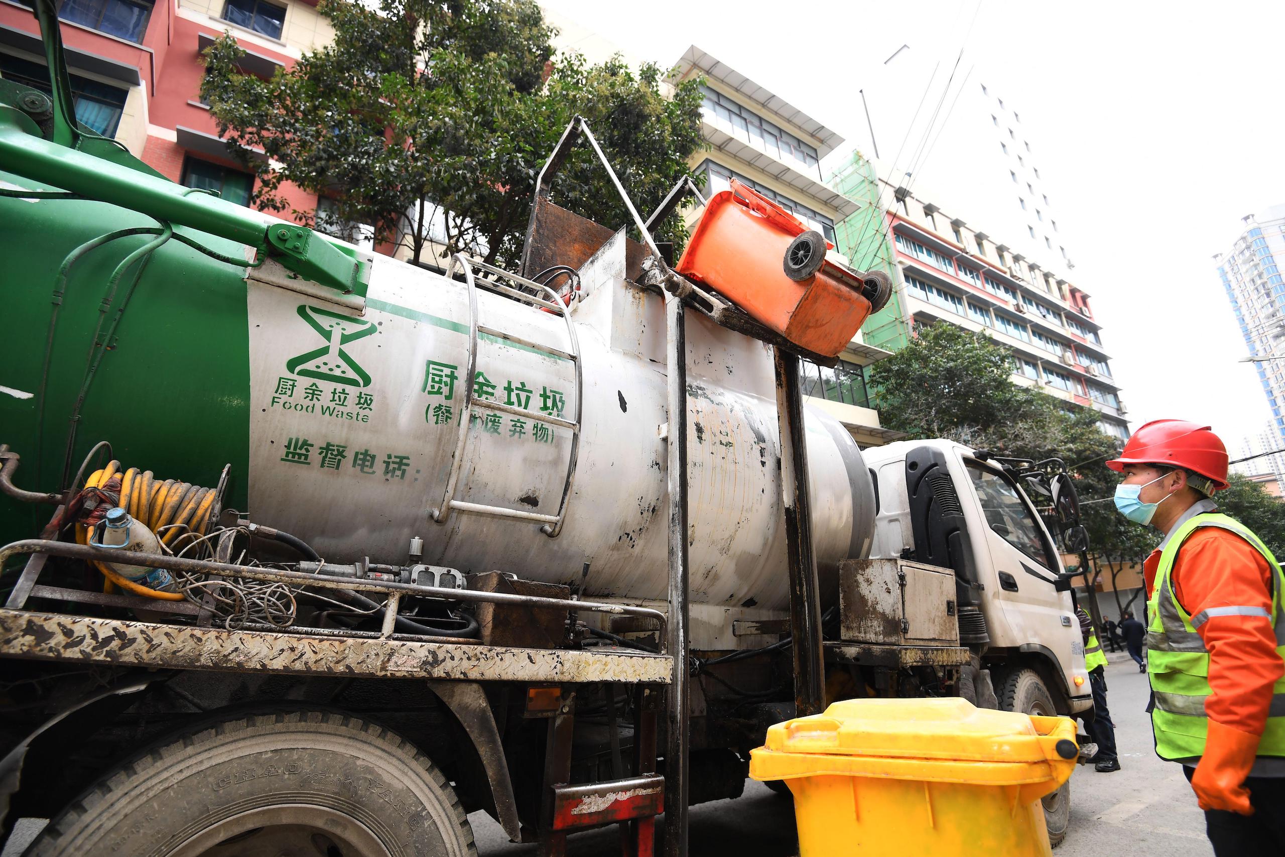 staff load food waste from restaurants into a food waste collection and transportation truck in Guiyang