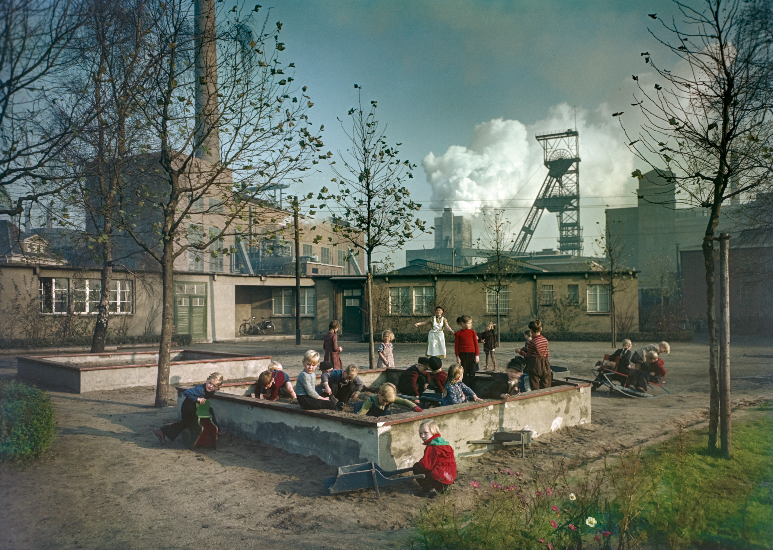 Kindergarten children play in a sandpit by the Emil-Emscher colliery in the Ruhr