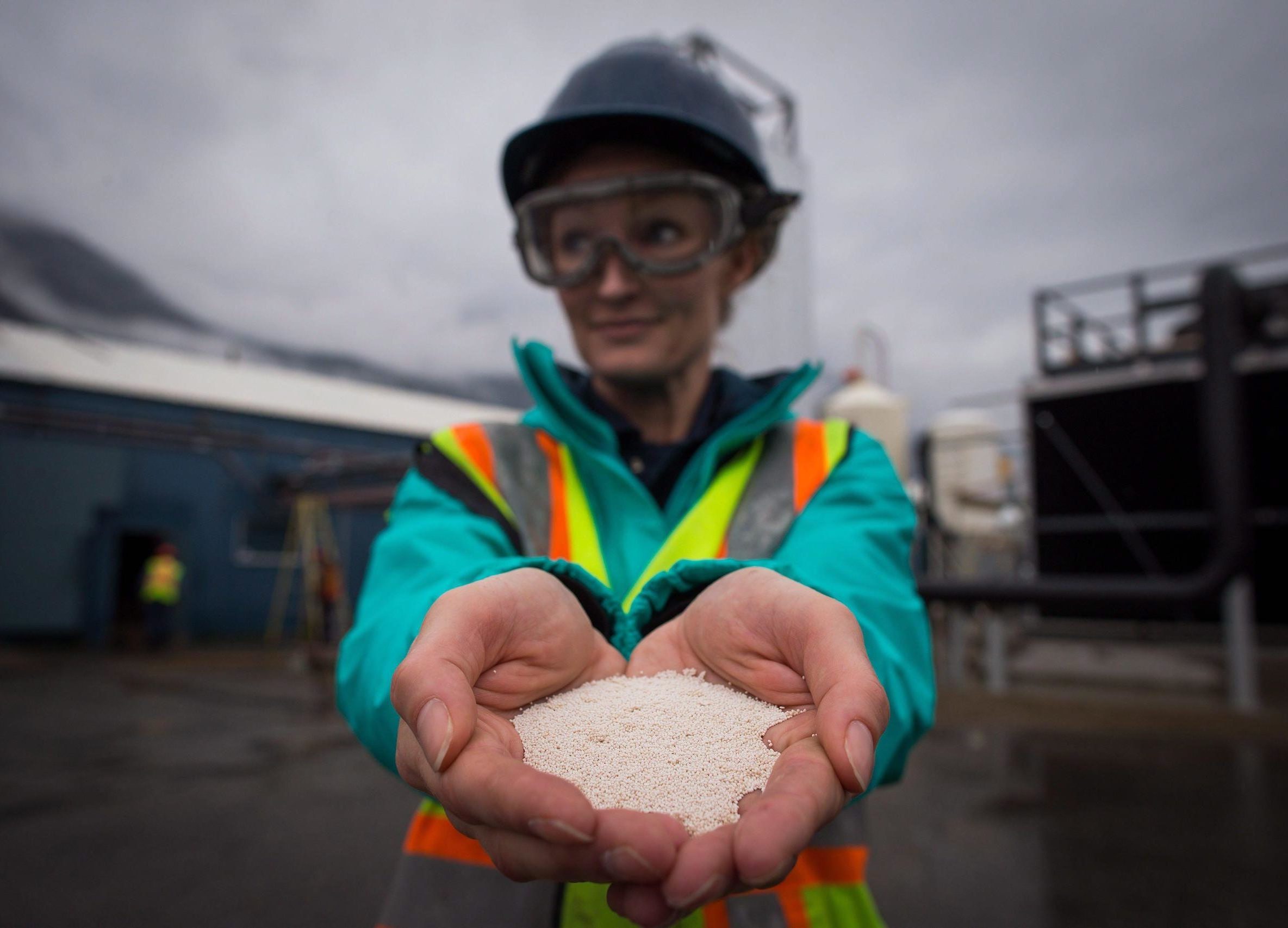 Engineer Jane Ritchie holds calcium carbonate pellets made from captured CO2 at the Carbon Engineering direct air capture plant in Squamish, Canada