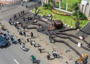 Activists install a giant "oligarchy monster" during a protest against Indonesia's Omnibus Law at the parliament building in Jakarta.