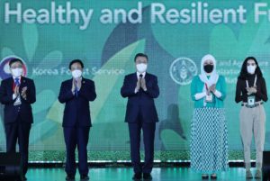 <p>South Korea’s former president Moon Jae-in (centre) is joined by delegates at the World Forestry Congress, hosted in Seoul, May 2022. (Image: BJ Warnick / Alamy)</p>