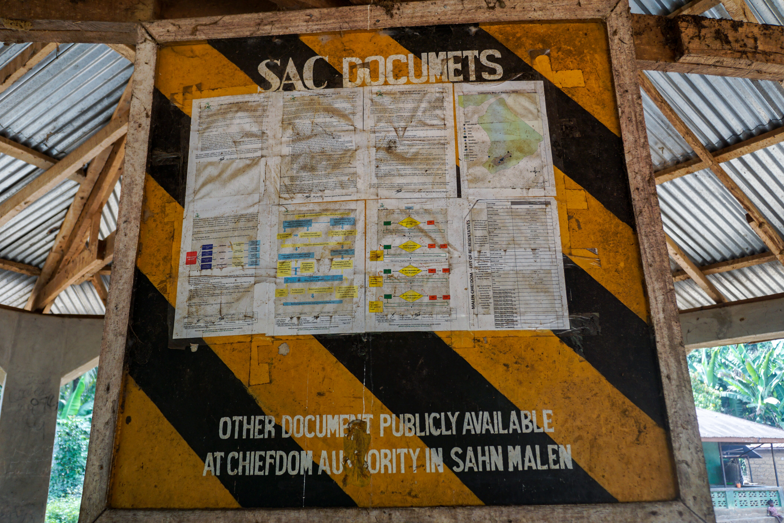 A public notice board in a Malen village meeting hall where SAC publishes information about its operations. 