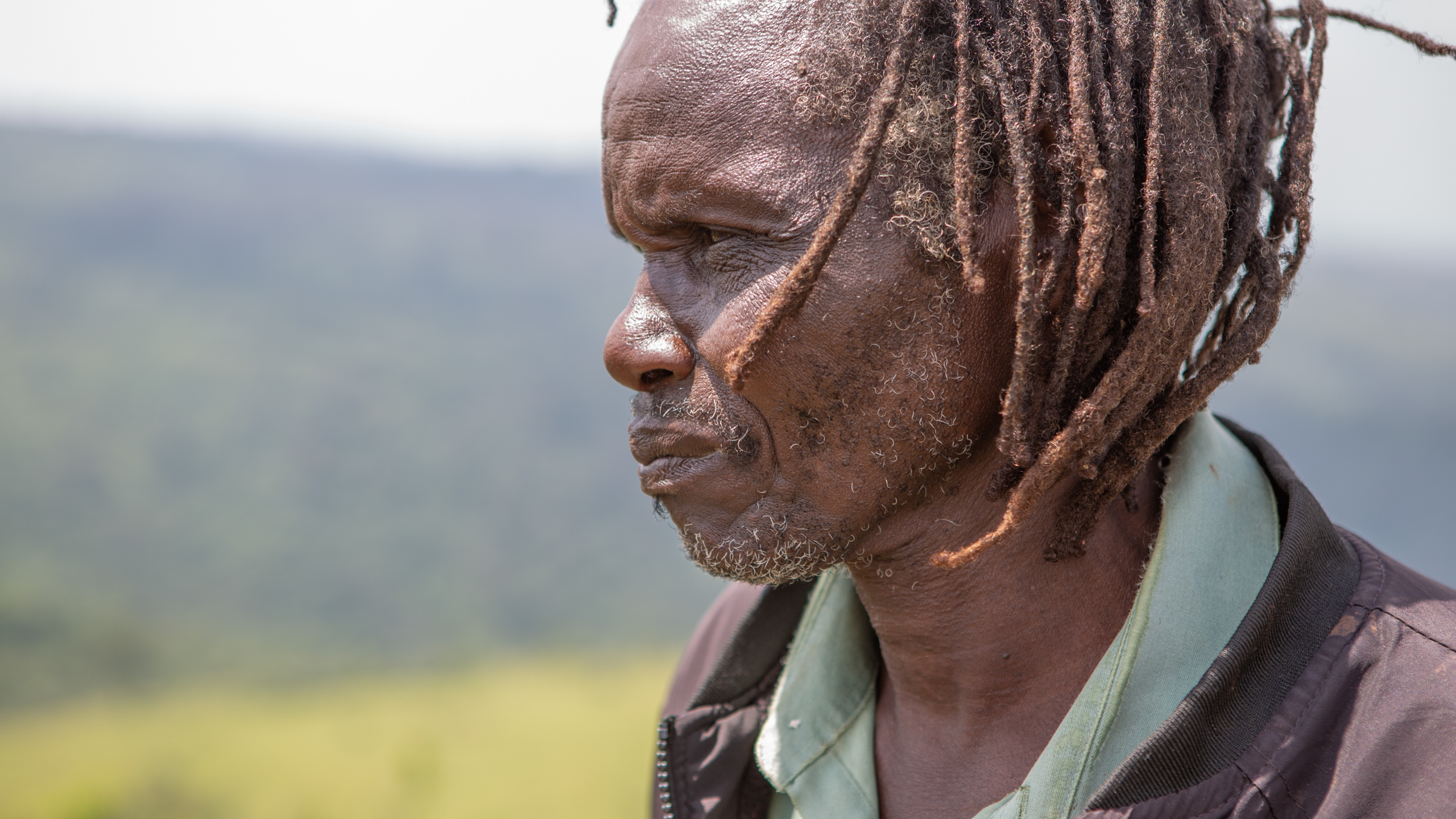 Ogiek elder Cosmos Murunga looks out across an area of ancestral land 