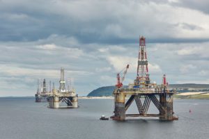 Large offshore oil rig drilling platforms off the coastline near Invergordon in Scotland