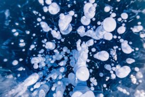 <p>Methane bubbles frozen in Lake Baikal, Siberia. Last year saw the biggest year-on-year jump in atmospheric methane since records began nearly 40 years ago. (Image: Evgenii Parilov / Alamy)</p>
