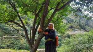 <p>Juthi Devi, daughter-in-law of one of the pioneers of the Chipko movement, clasps the trunk of a tree in Raini village in October 2022. Almost 50 years ago, women in Raini, Uttarakhand, used their bodies to shield the trees in their forests from loggers and in the process sparked a global conservation movement. (Image: Varsha Singh)</p>