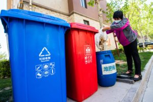 <p>Putting kitchen waste into a composting bin in Qingzhou, Shandong province (Image: Wang Jilin / Alamy)</p>