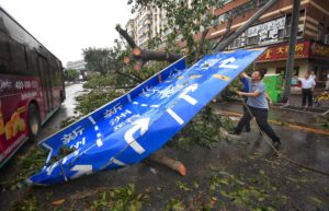<p>Clearing a Shenzhen sign felled by Typhoon Mangkhut. Since the 2021 Henan floods, the central government has been promoting a rain warning model developed in Shenzhen for use nationwide. (Image: Mao Siqian / Alamy)</p>