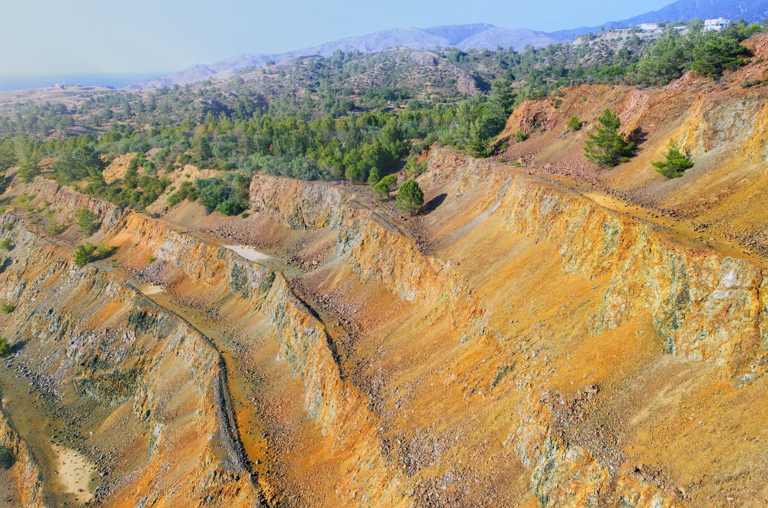 half forested open mine