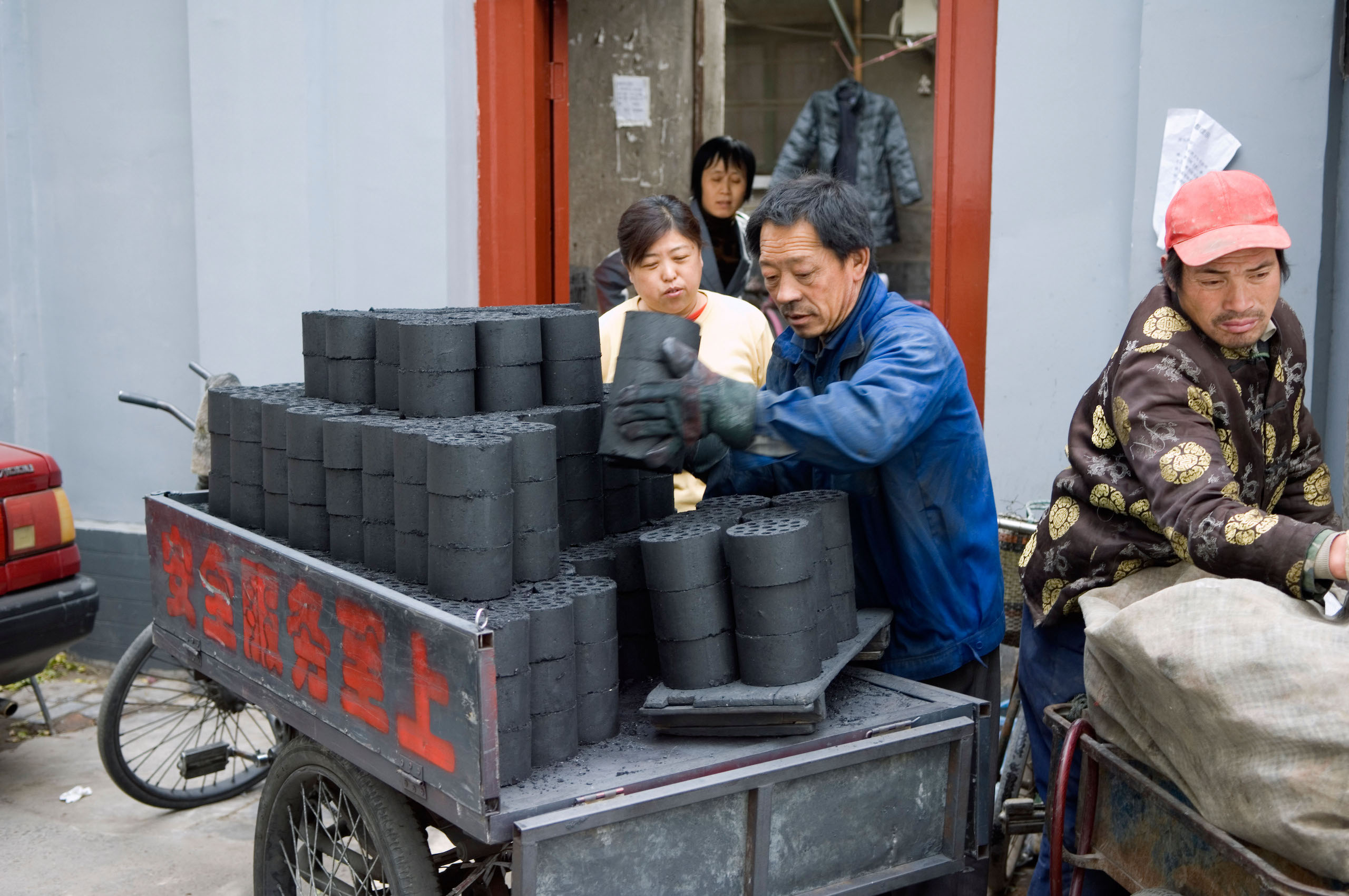 Charcoal bricks being delivered to local hutong homes Beijing China