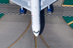 Delta Air Lines plane seen from above over taxiway lines