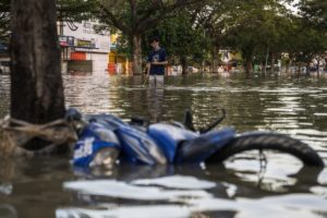 man standing in thigh high flood