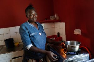 Smiling woman next to a gas stove