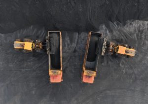 Two trucks transport coal at the port coal terminal yard