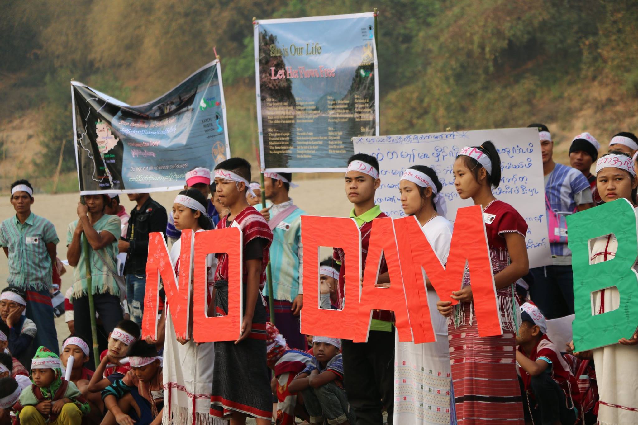 people holding up protest signs