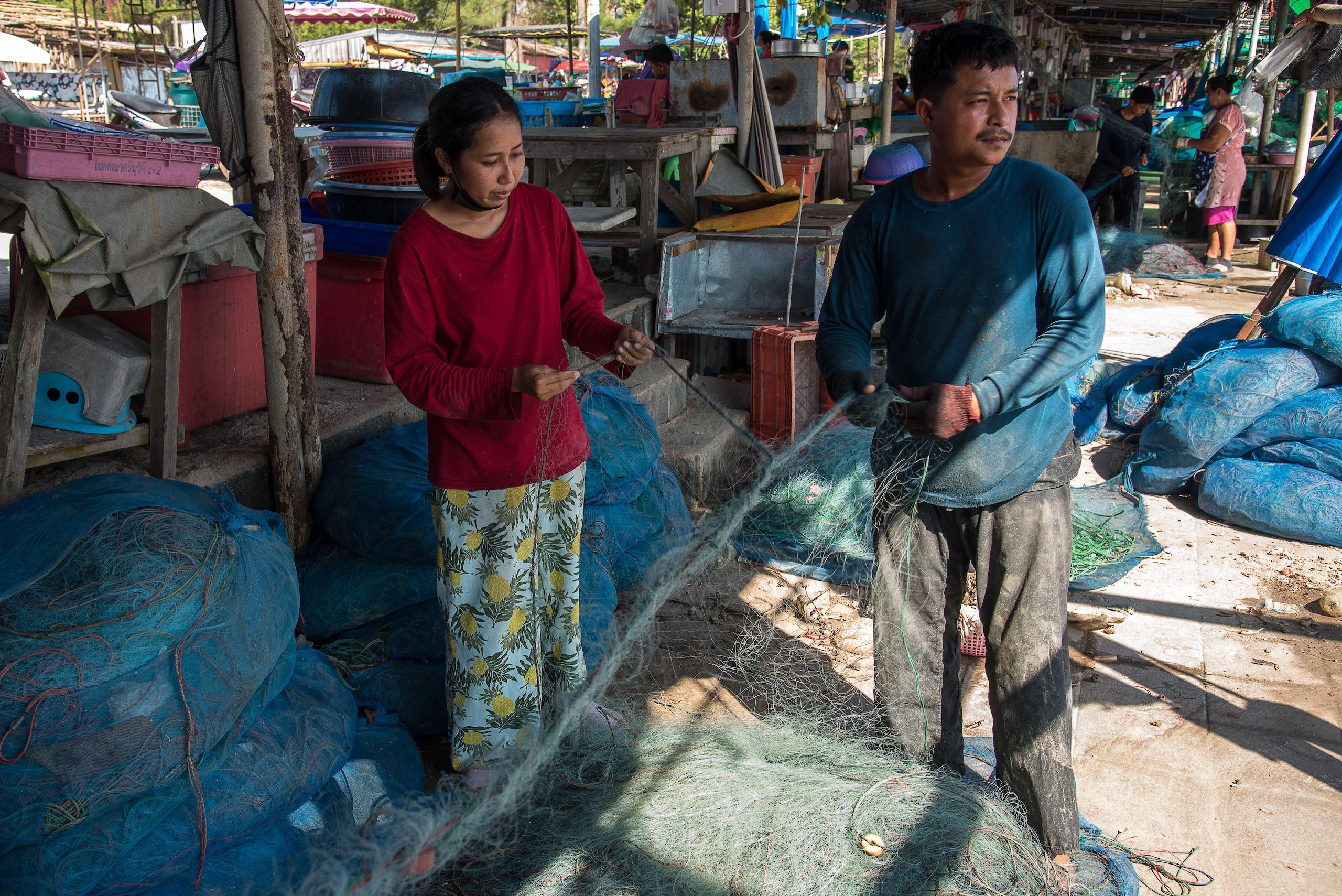 Man and woman holding fishing nets